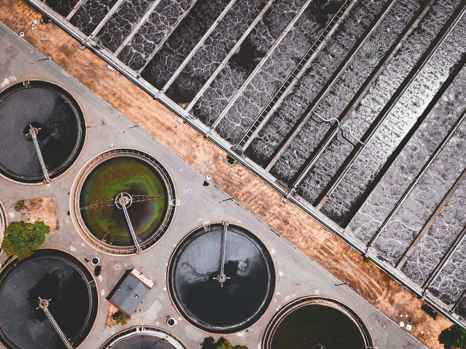 Aerial view of circular water-treatment basins and aeration lanes